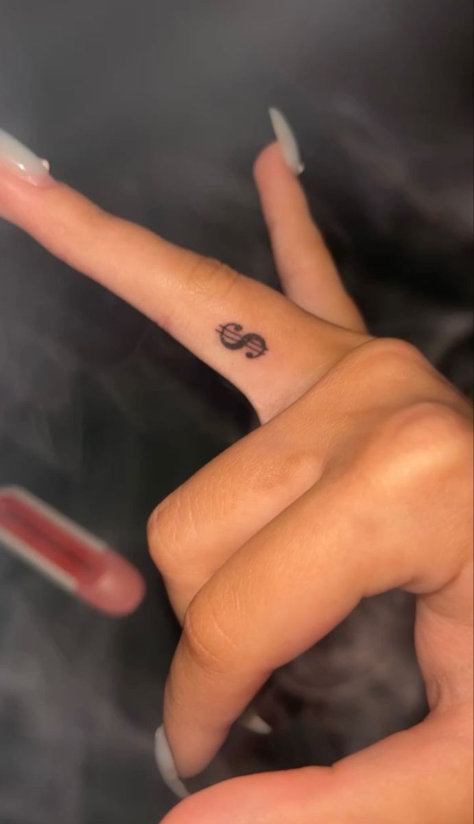 Dollar tattoo,tattoo,finger tattoo Money Sight Tattoo, Money Sign Tattoo On Finger, Dollar Sign Finger Tattoo, Red Dollar Sign Tattoo, Coin Size Tattoo, Small Hand Tats For Women, Tattoos To Hide From Parents, Hot Small Tattoos, Money Tattoo Ideas For Women