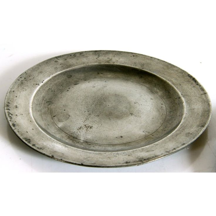 a silver plate sitting on top of a white table