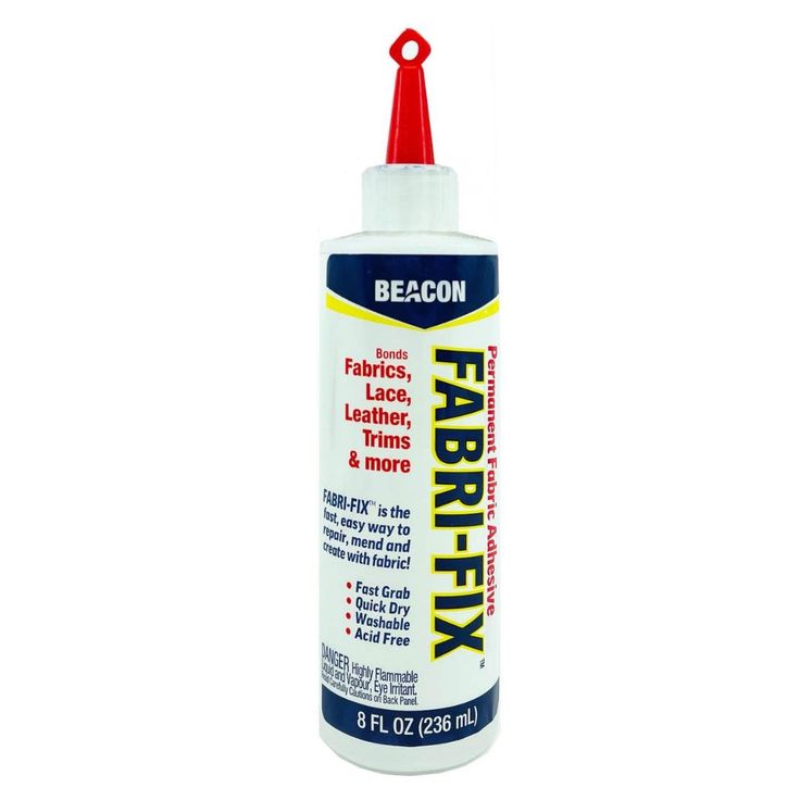 a close up of a bottle of fabric fixant on a white background with a red cap