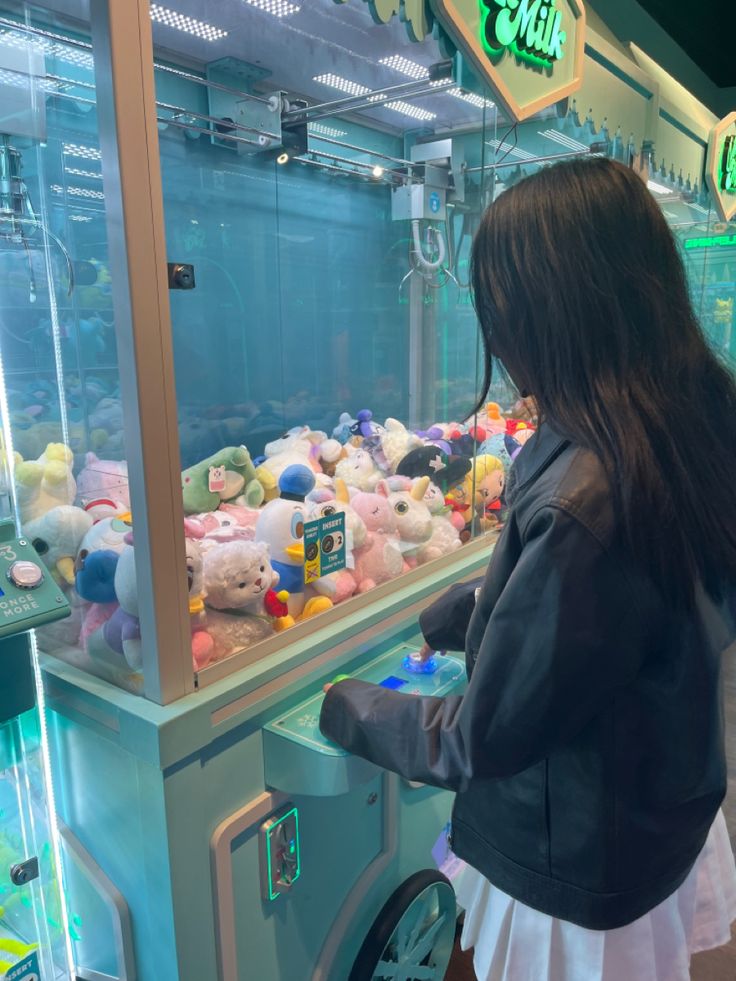 a woman looking at stuffed animals in an aquarium