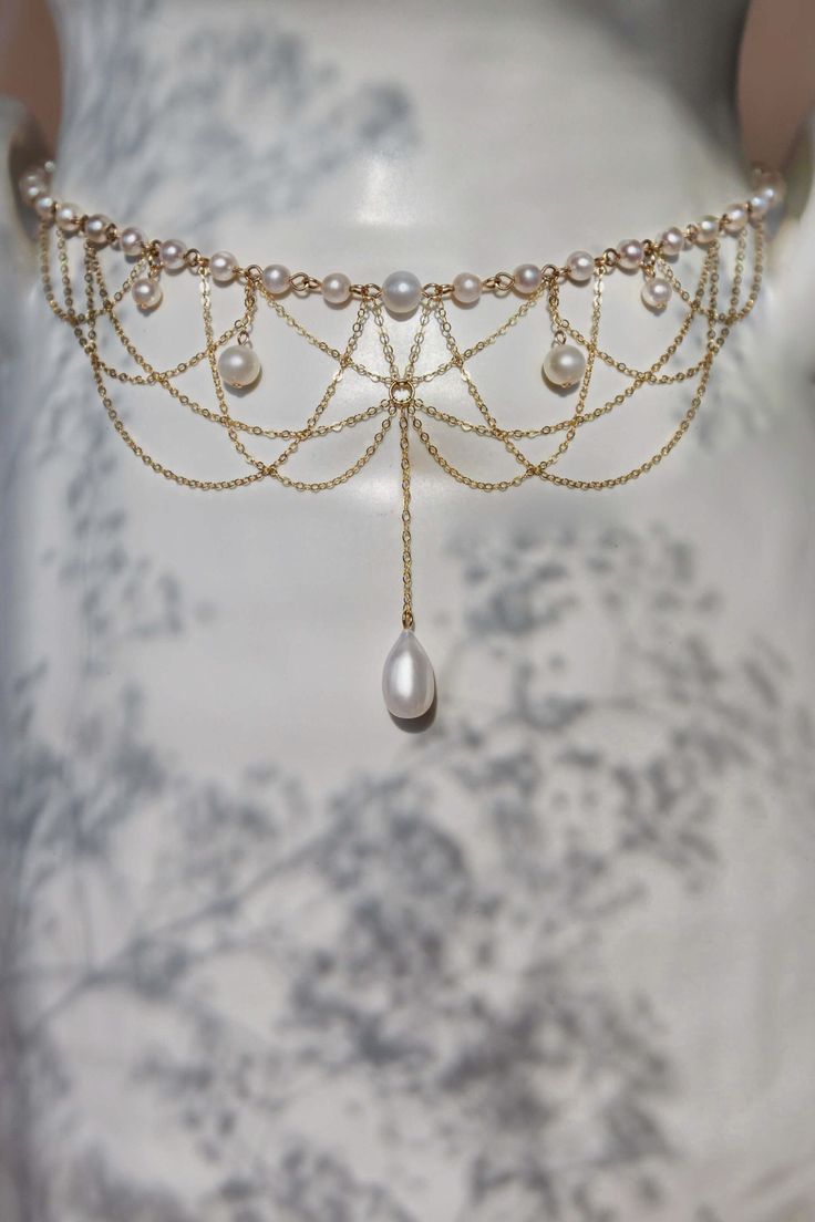 The Diane Pearl Necklace is intricately handcrafted with 14k gold-filled chain and freshwater pearls dangling elegantly from a strand of scintillating connected freshwater pearls. Preorder 7-10 days send out. 40cm/16 inches in length. Packaged in an elegant plastic-free reusable jewelry box, this necklace makes the perfect gift or special treat for oneself. Note: This very intricate necklace can tangle even with our utmost care in sending, please be gentle and patient to untangle and place in th Diy Freshwater Pearl Necklace, Shoulder Necklace Wedding, Pearl Star Necklace, Elegant Pearl Necklace With Chain For Wedding, Elegant Wedding Pearl Necklace With Chain, Gold Pearl Drop Necklace For Party, Party Gold Pearl Drop Necklace, Elegant Gold Dangle Backdrop Necklace, Gold Pearl Necklace With Dangling Beads For Wedding