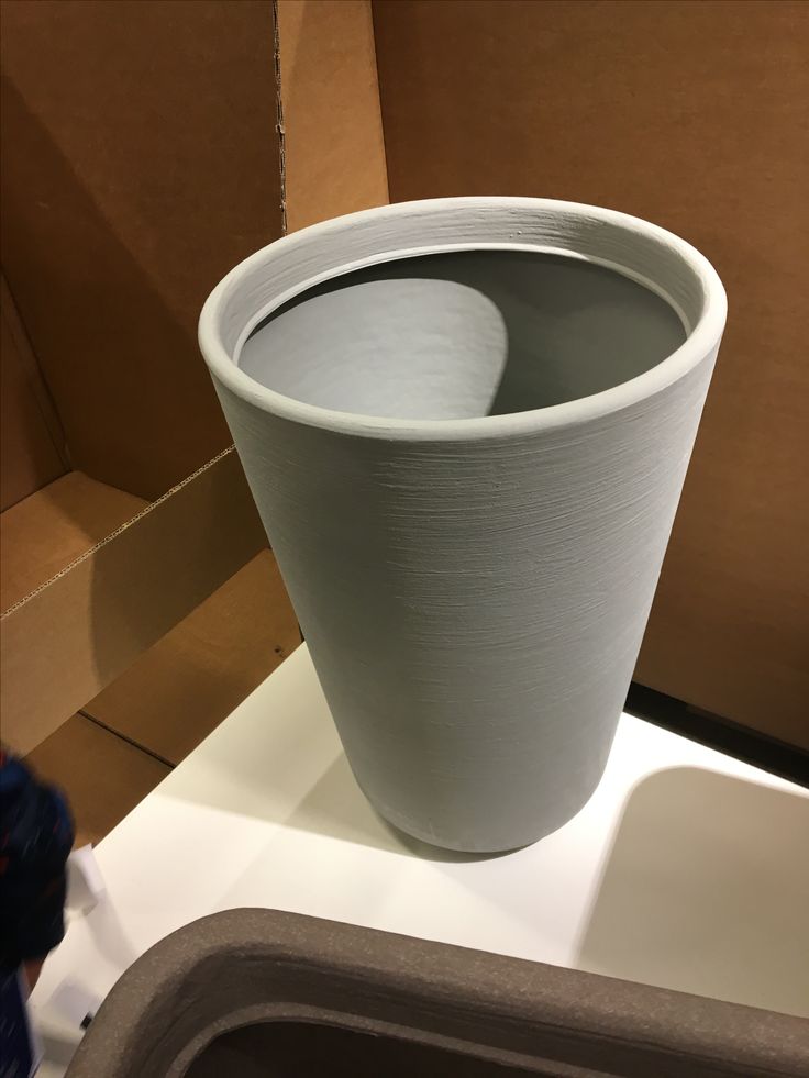 a large white vase sitting on top of a counter