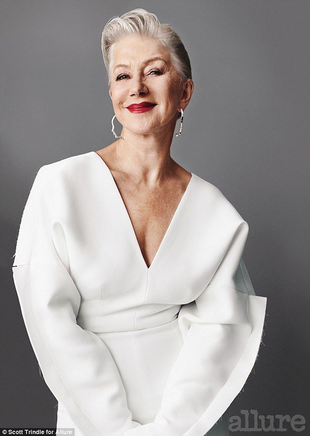 an older woman in a white dress posing for the camera with her hands on her hips