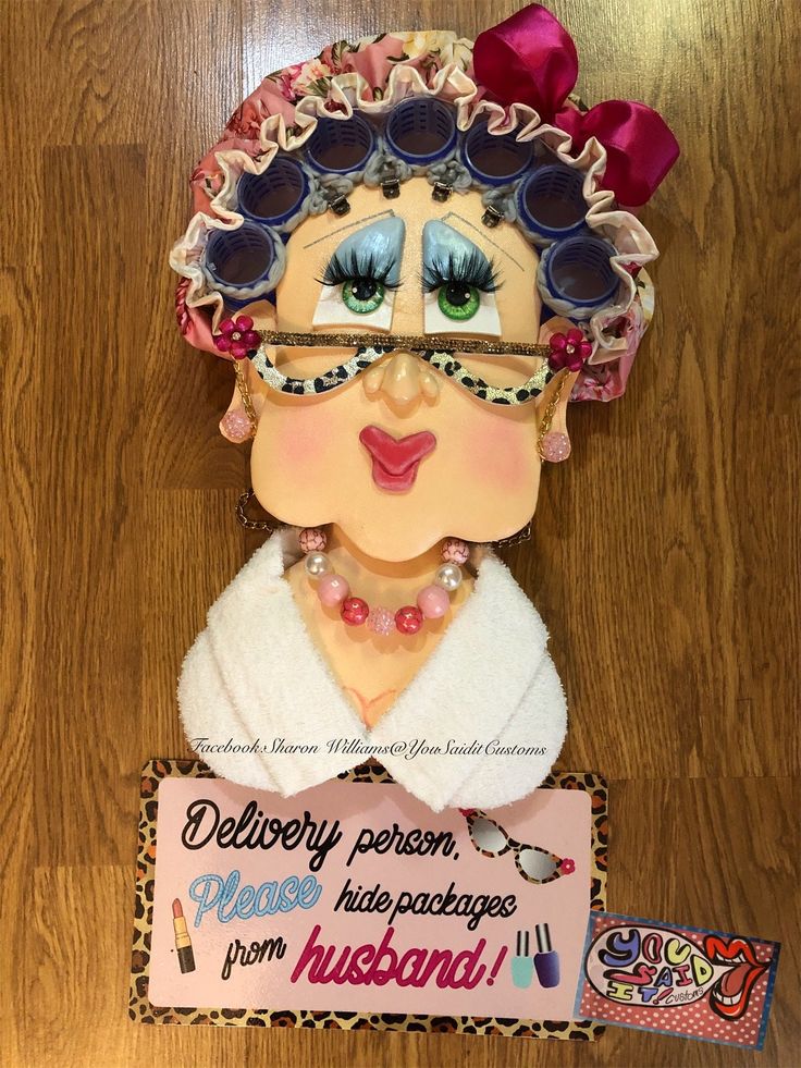 a paper doll with glasses and a name tag on it's head, next to a sign that says delibery person please have packages from husband