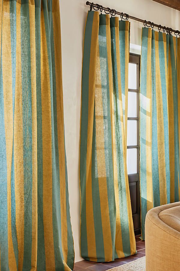 a living room with yellow and green striped curtains