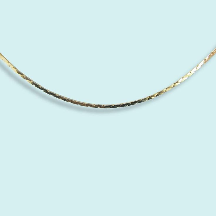 A sleek serpentine chain. Perfect for layering. Metal: 14kt gold plating over brass Size: 18" Chain Spring Clasp Made in the USA