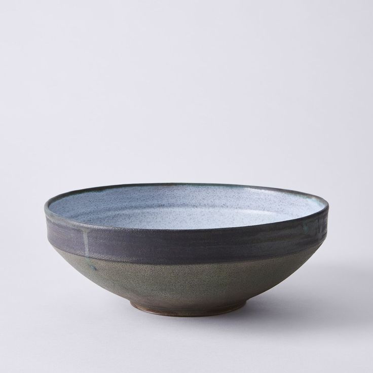 a gray and black bowl sitting on top of a table