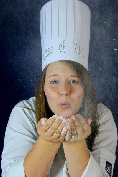 a woman wearing a chef's hat with writing on it