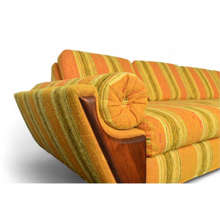 an orange and yellow striped couch sitting on top of a white floor