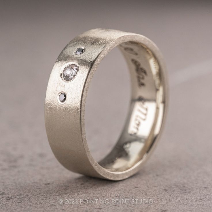 a wedding ring with three diamonds on it