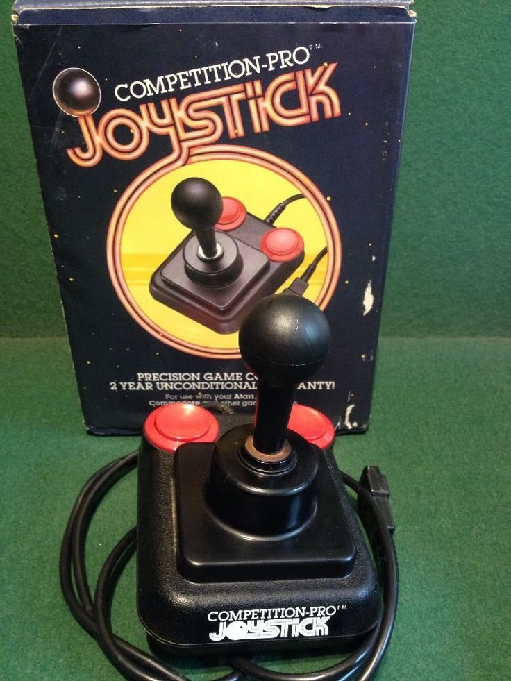 a black joystick sitting on top of a green table