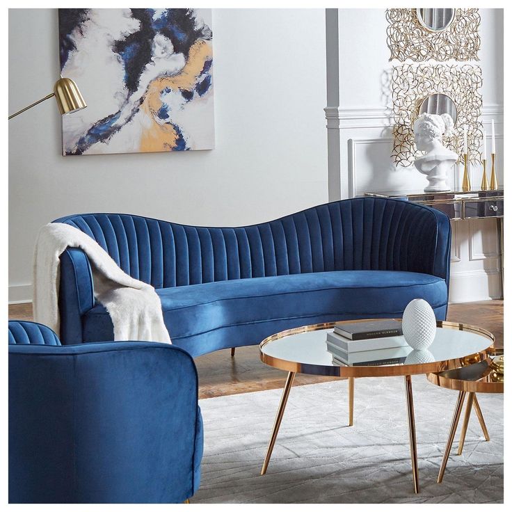 a living room with two blue couches and a coffee table