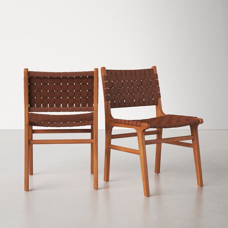 two chairs sitting next to each other on a white floor