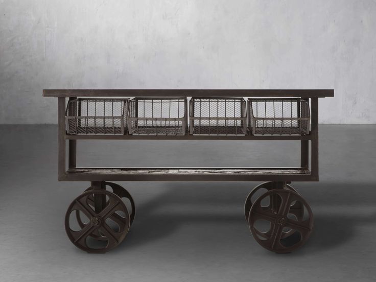 an old wooden cart with three baskets on it's wheels, against a gray background