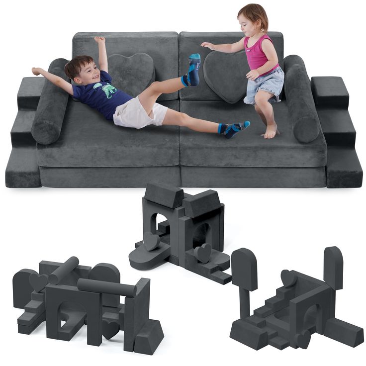 two children are laying on a couch with letters and blocks in the shape of letters