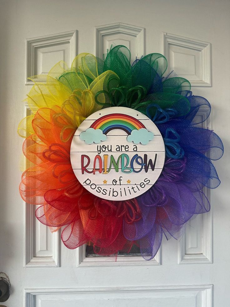 a rainbow door hanger with you are a rainbow of possibilities on the front door