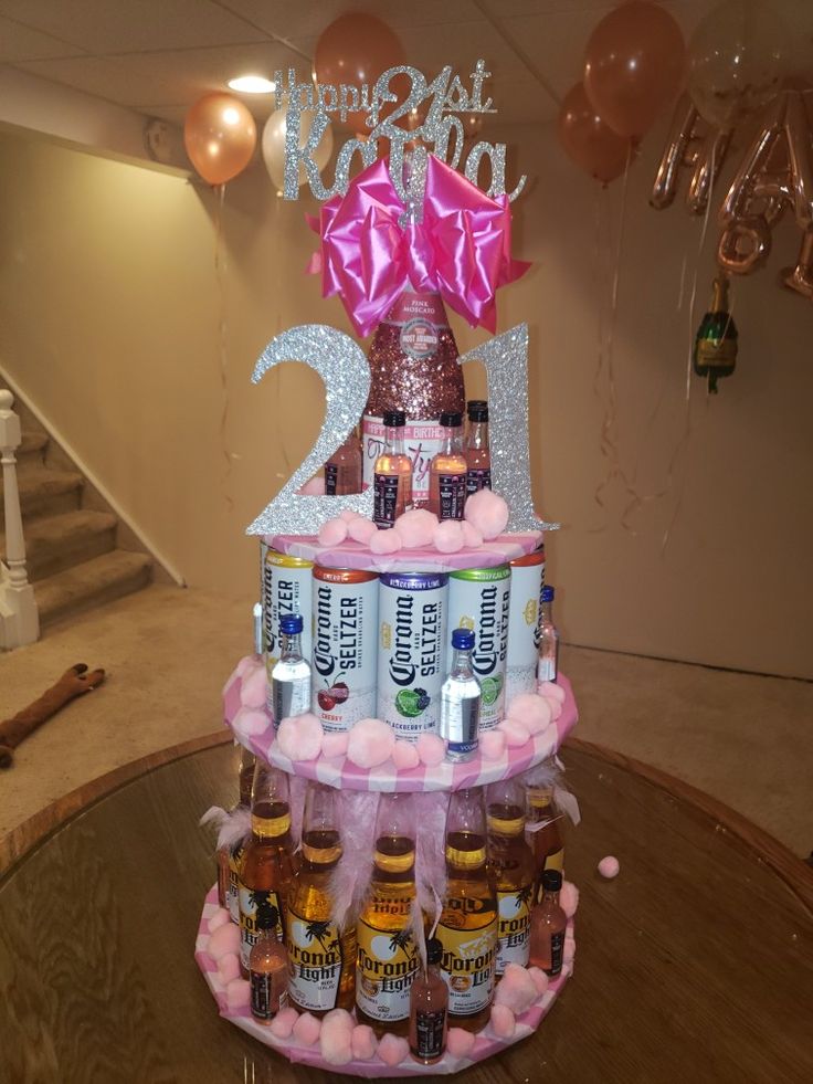 a birthday cake made to look like a tower with beer bottles and balloons on top