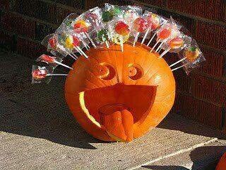 a pumpkin with candy sticks sticking out of it's mouth