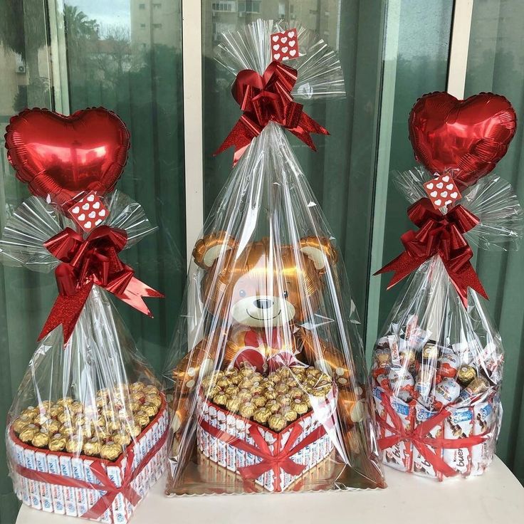 three baskets filled with chocolates and teddy bears