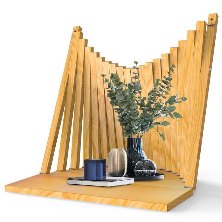 a vase with some flowers and books on a table next to a wooden wall divider