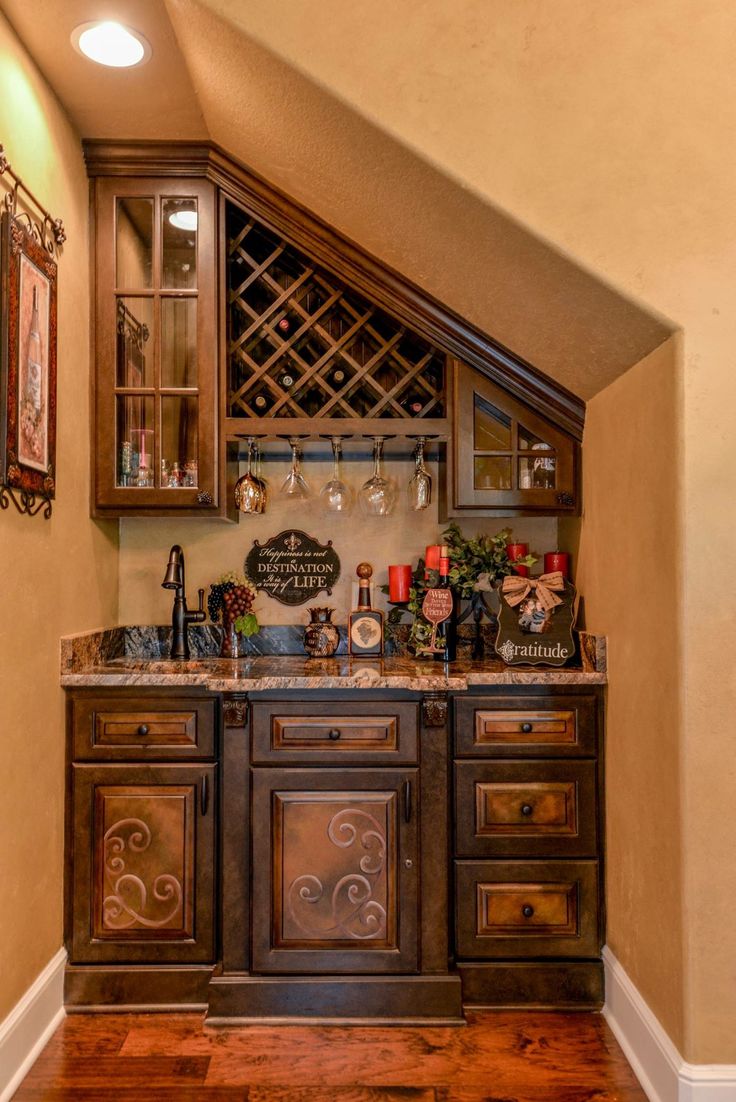 a wine rack in the corner of a kitchen with wooden floors and walls, along with an arched ceiling