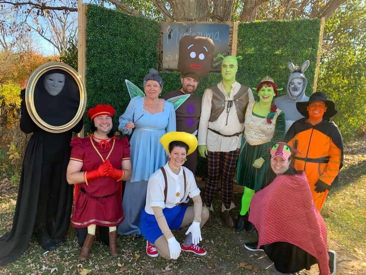 a group of people in costumes posing for a photo