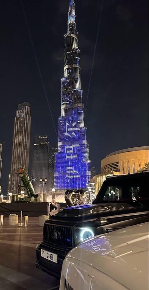 the burj building is lit up in blue and white to celebrate new year's eve