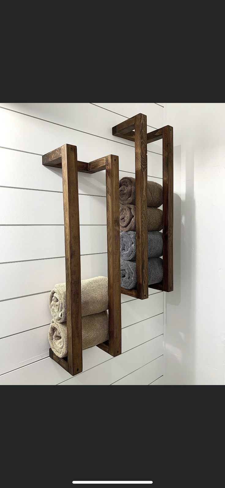 a wooden shelf that has towels on it