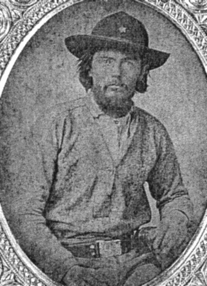 an old black and white photo of a man wearing a cowboy hat