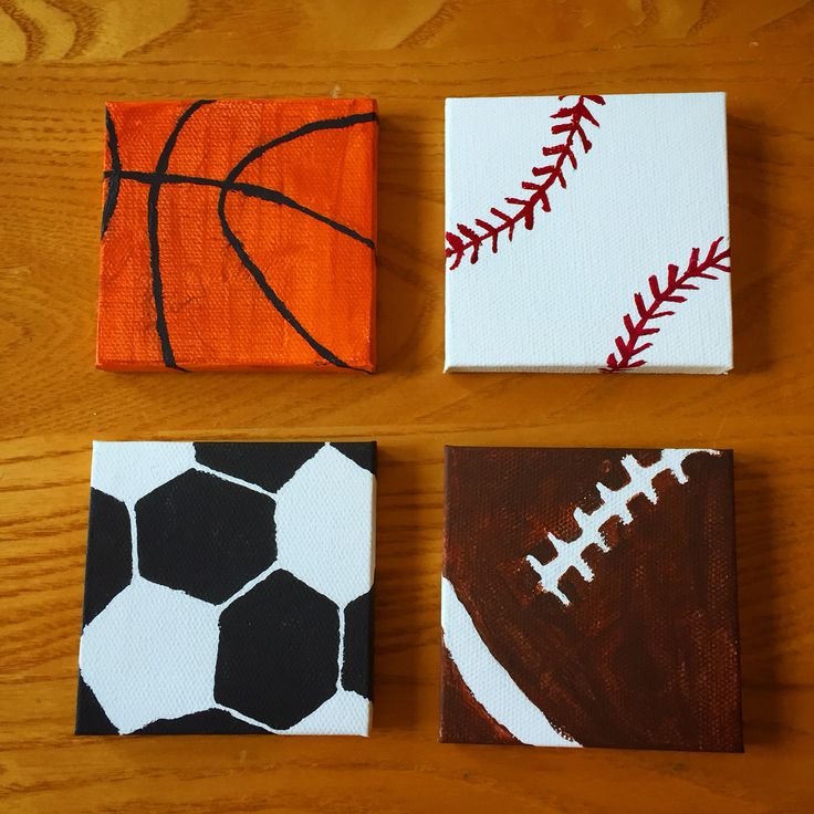 three canvases with different designs on them are sitting on a table together, one has a basketball and the other is a football