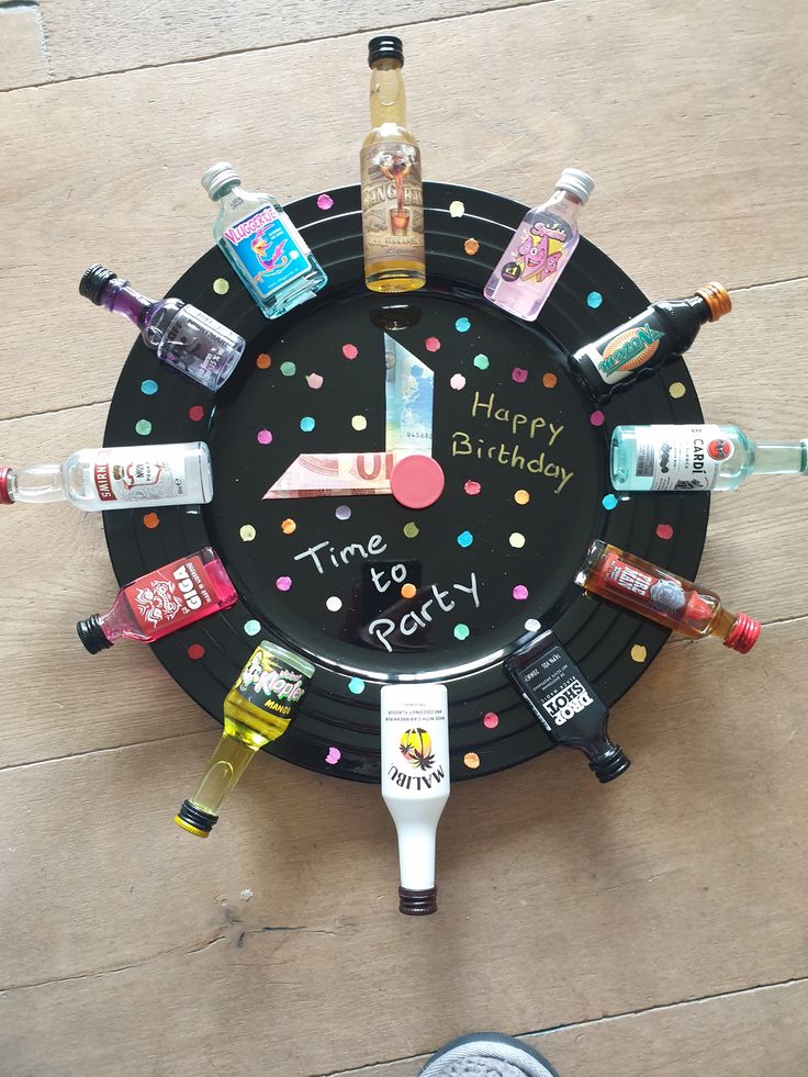 a birthday cake plate with liquor bottles and confetti on it that says happy birthday time to party