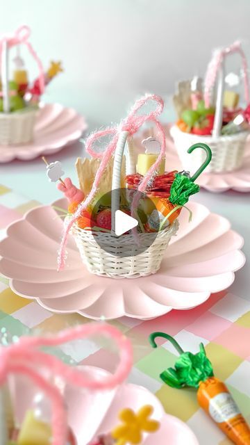 small baskets filled with candy and candies on pink plates