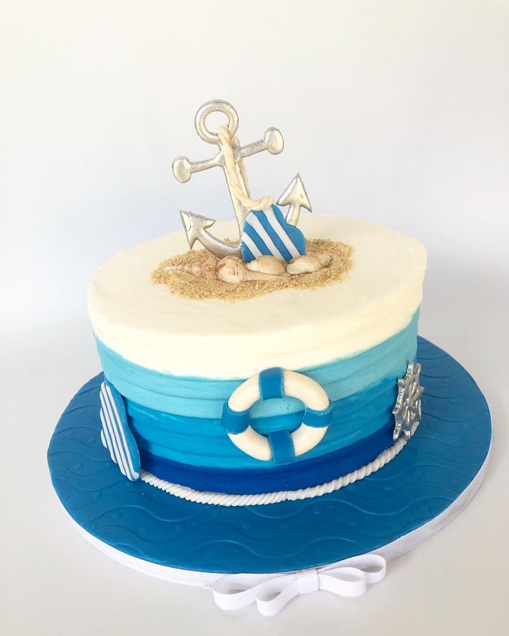 a blue and white cake with an anchor on top