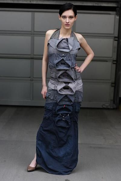 a woman standing in front of a garage door wearing a dress with ruffles