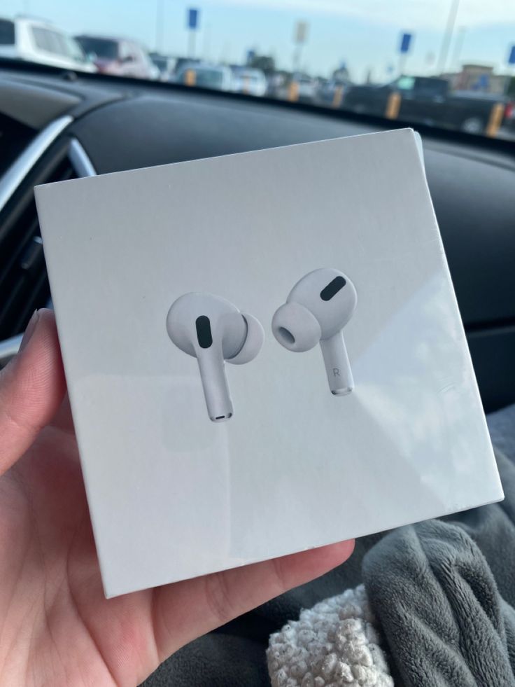 someone is holding up an apple airpods in their hand