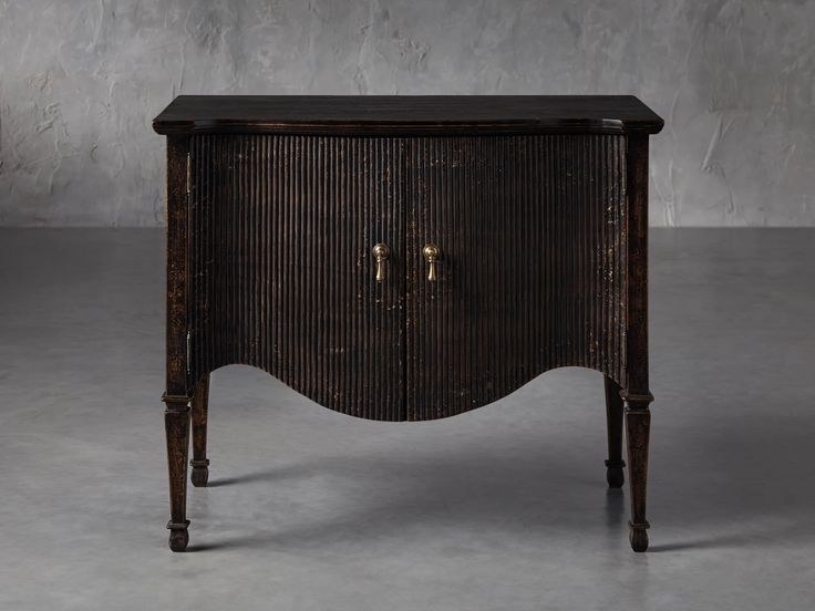 an old wooden cabinet sitting on top of a cement floor