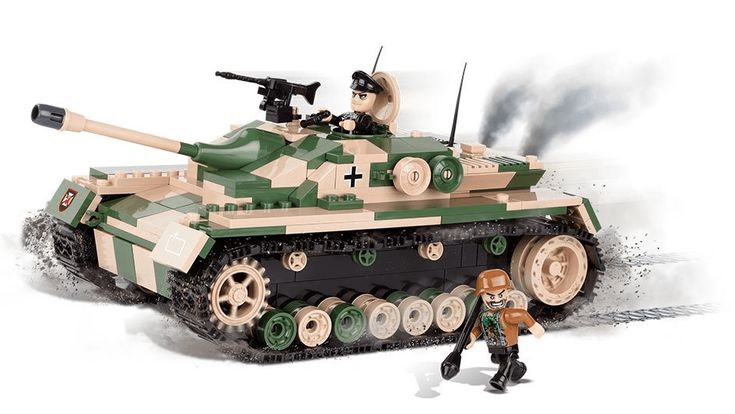 a toy soldier standing next to an army tank