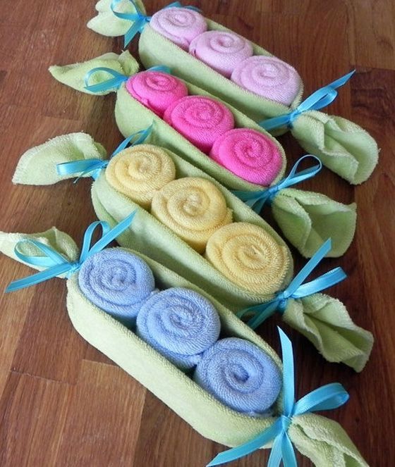 three rolls of rolled up soaps with different colors and designs on them sitting on a table