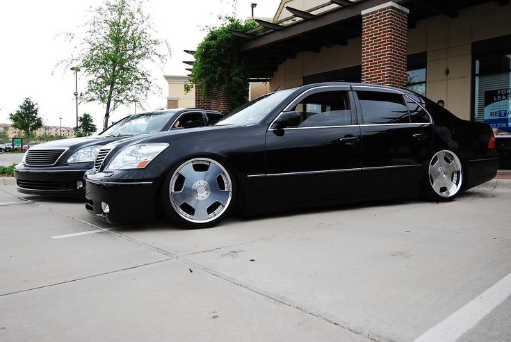 two black cars parked in front of a building