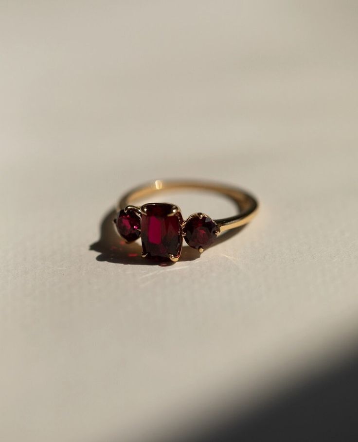 Red Ruby Diamond Ring, Three Stone Gemstone Ring, Elongated Cushion & Round Cut Engagement Ring, Past Present Future Wedding Ring, 14K Gold Item Description: Stone - Simulant Diamond Stone Shape - Elongated Cushion & Round Cut 1. White Gold: 10K/14K/18K 2. Yellow Gold: 10K/14K/18K 3. Rose Gold: 10K/14K/18K 4. Silver: Sterling Silver 925 Size Customization: What Size you want... * You can also Customize ring size in US 4 to US 12! It sometimes affects to price. * Main Stone & Shape Customization: Antique Ring Round Stone, Square Ruby Engagement Rings, Engagement Ring With Small Ruby, Gold Gemstone Ring Set, Elegant Luxury Ruby Ring Gift, Luxury Heirloom Garnet Rings, Antique Ruby Ring Stone, Raw Ruby Engagement Rings, Luxury Dainty Ruby Engagement Ring