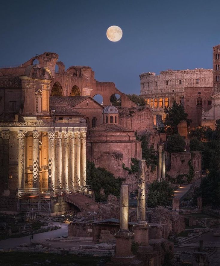 the full moon is setting over an ancient city