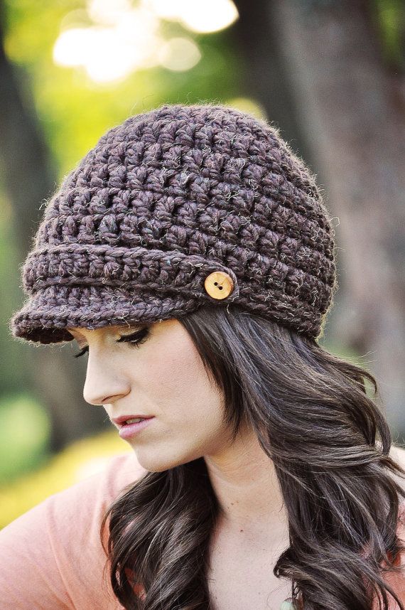 a woman wearing a crocheted hat with buttons on the front and back of her head