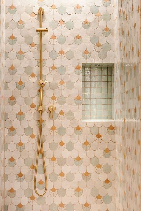 a bathroom with a shower head and tiled walls