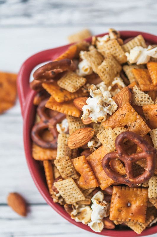 a red bowl filled with cheetos and pretzels