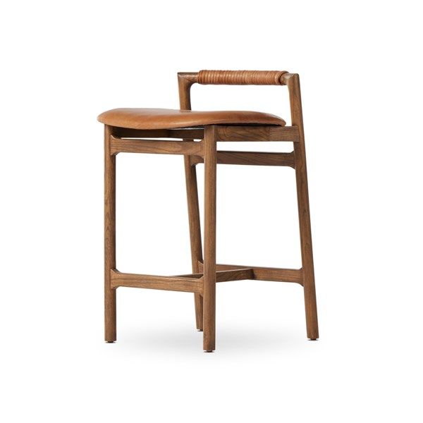 a wooden stool with a leather seat and back rest on a white background in the foreground