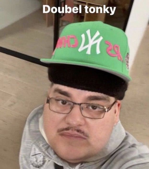 a man wearing a green hat with the words double tonky in red on it