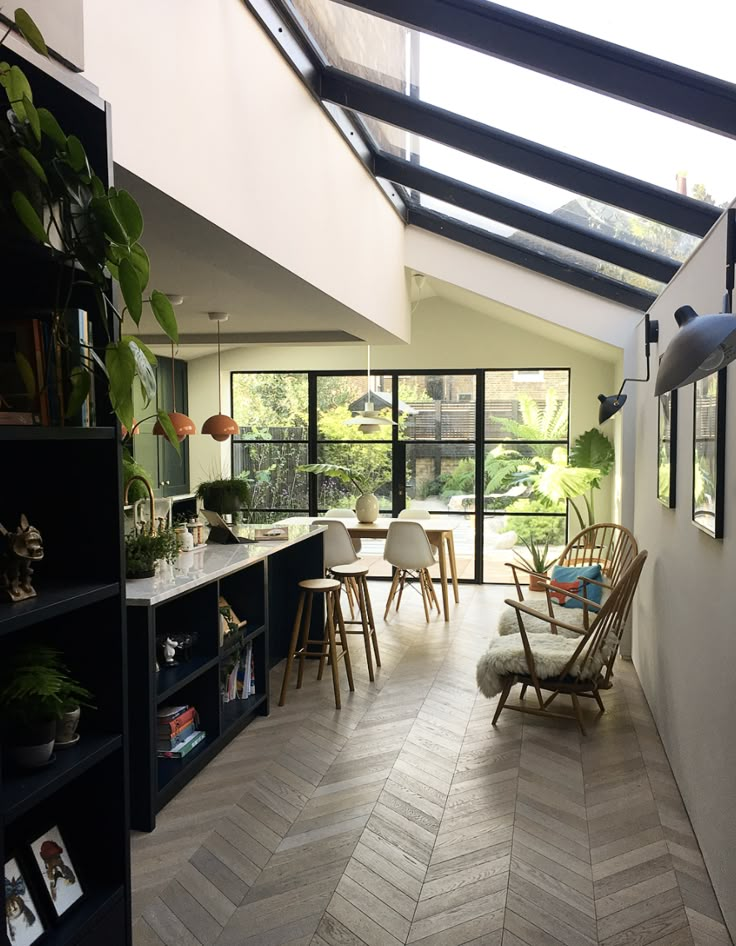 an open kitchen and dining room with skylights