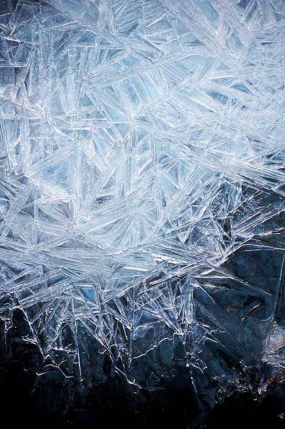 an ice covered surface with small pieces of frost on it's edges and the top part of the image partially visible