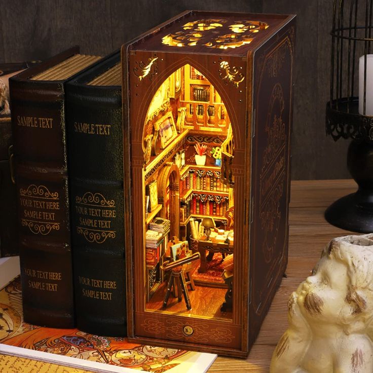 an open book case sitting on top of a wooden table next to two other books