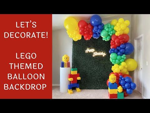 balloons and legos decorate the entrance to a birthday party